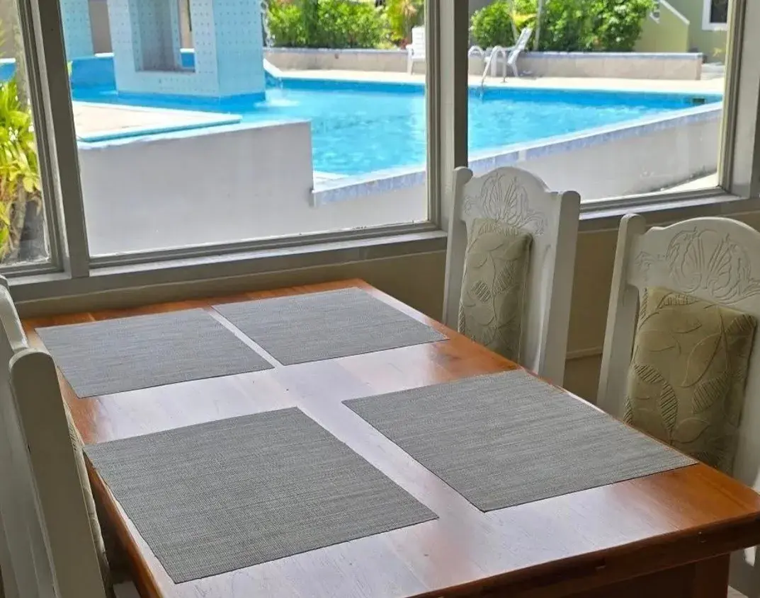 Dining table by the window overlooking the pool