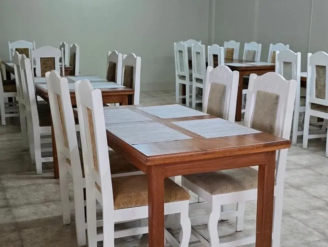 Bright dining room with white timber chairs