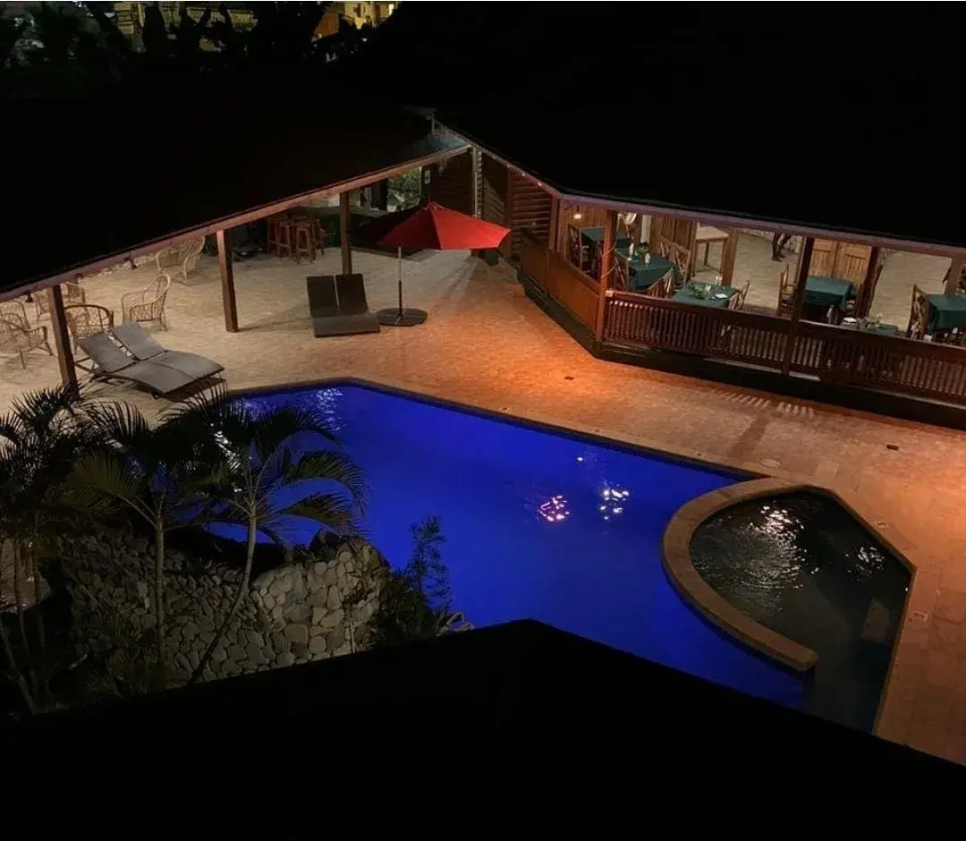 The pool and courtyard glowing at night
