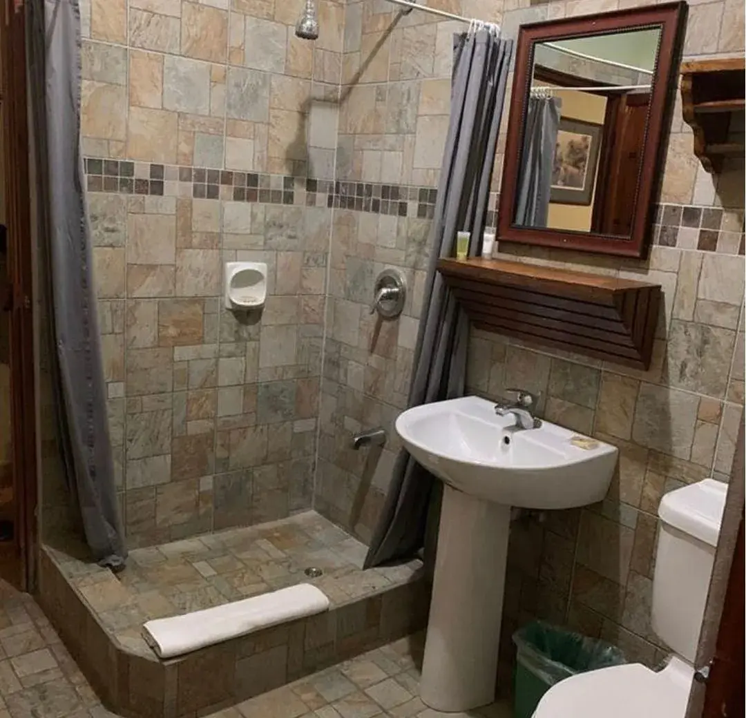 En-suite bathroom with stone-tiled walk-in shower