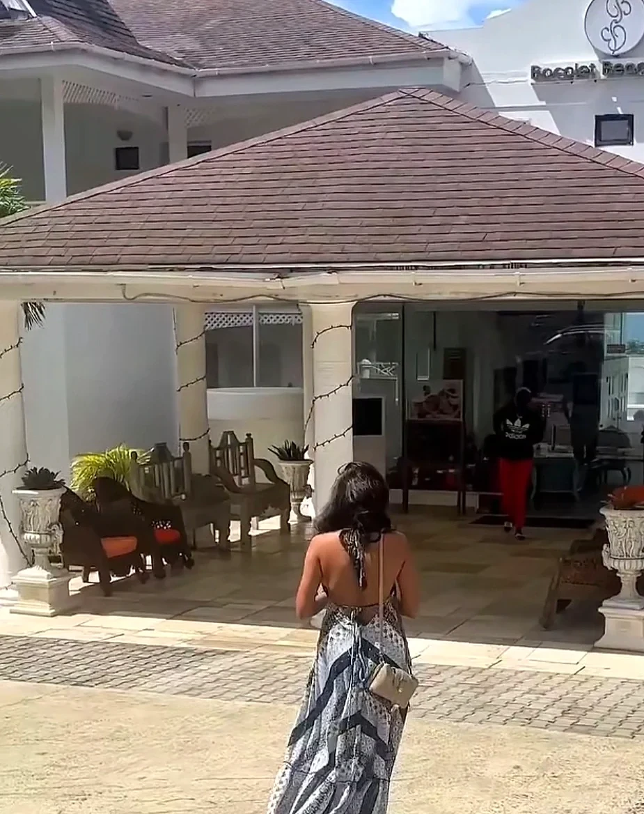 Guest walking up to the covered reception entrance of Bacolet Beach Club