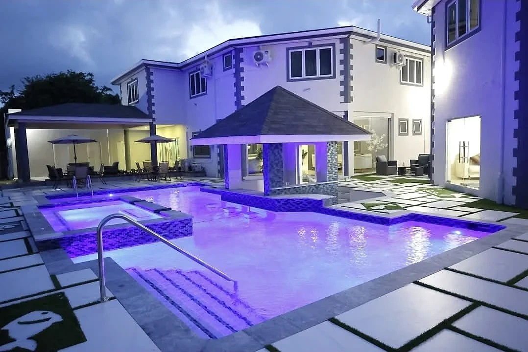 Escarlet Hotel courtyard pool illuminated beneath the evening sky
