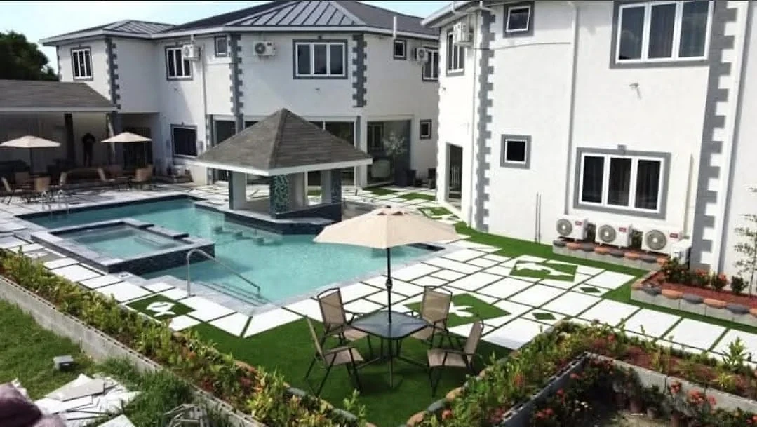 Daylight view over the courtyard pool and white hotel buildings