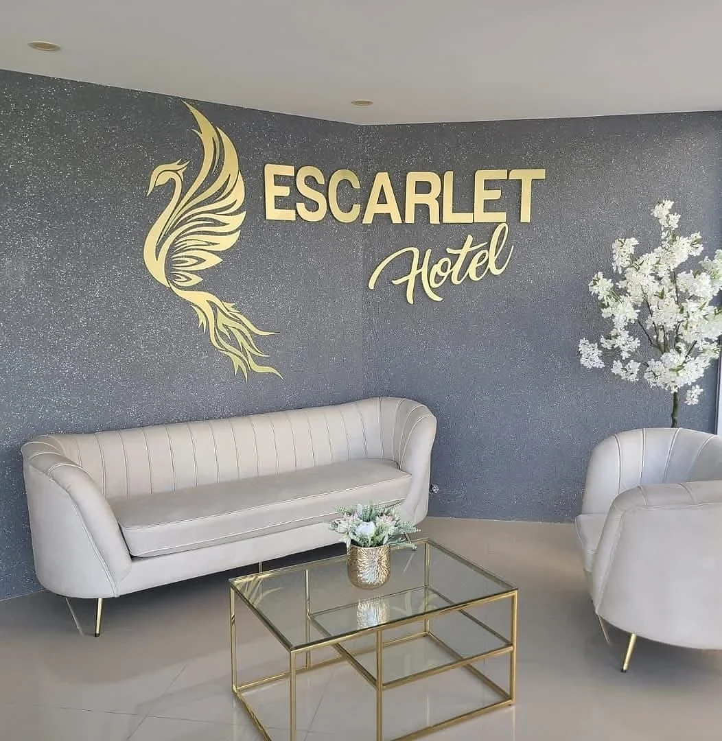 Escarlet Hotel reception lounge with gold phoenix branding