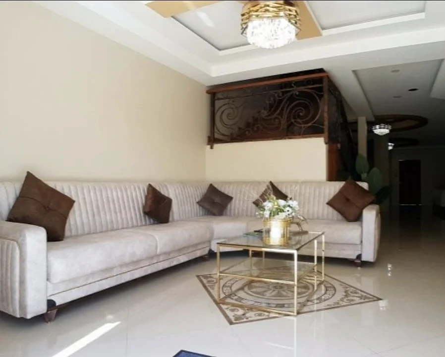 Bright lobby seating area with polished floors and chandeliers