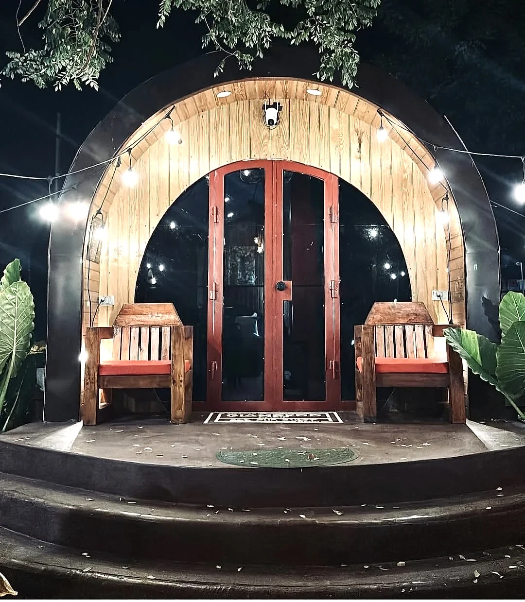 Glampedd cabin entrance illuminated at night