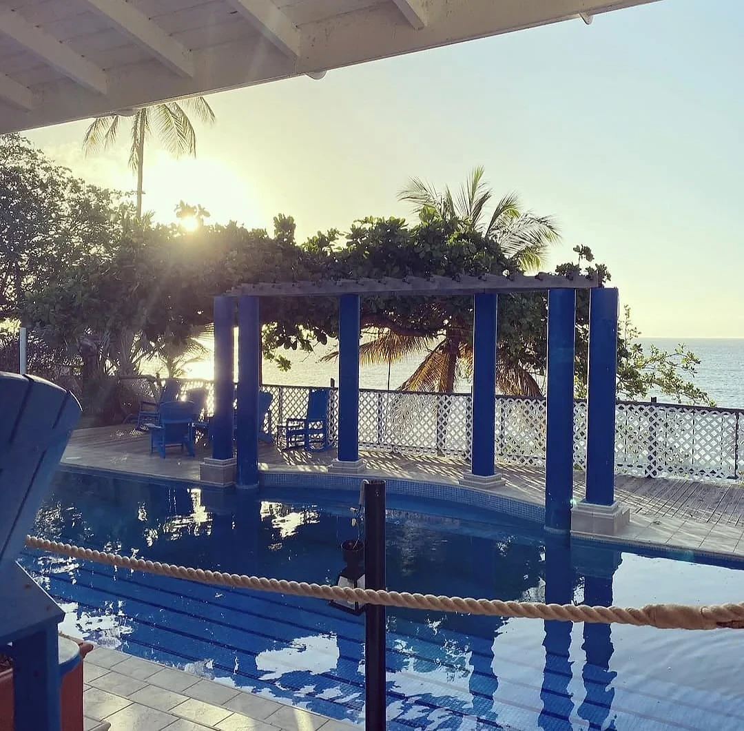 Sunset over the poolside pergola at Sapodilla Villa