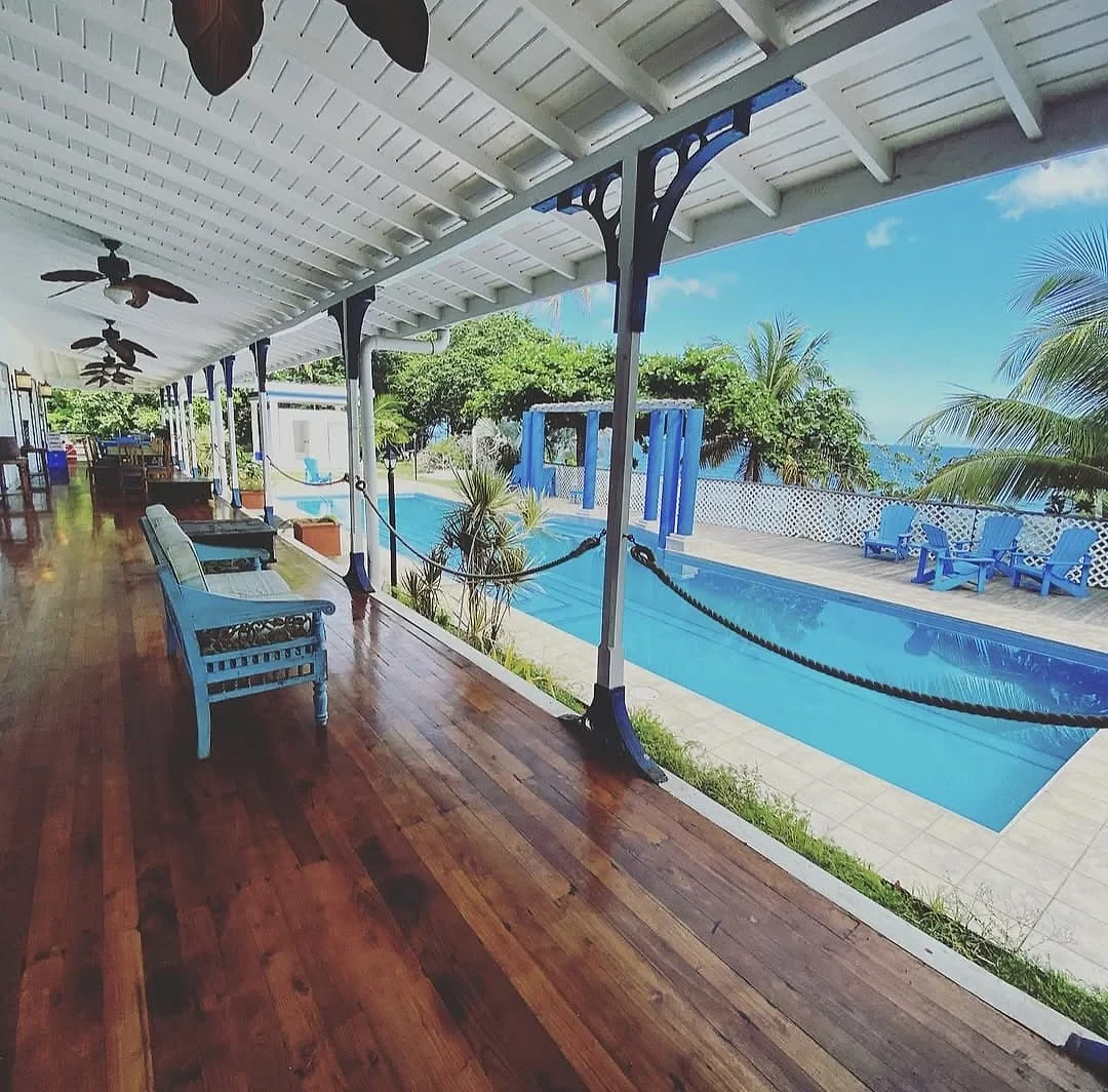 Pool terrace and shaded veranda overlooking the Caribbean Sea at Sapodilla Villa