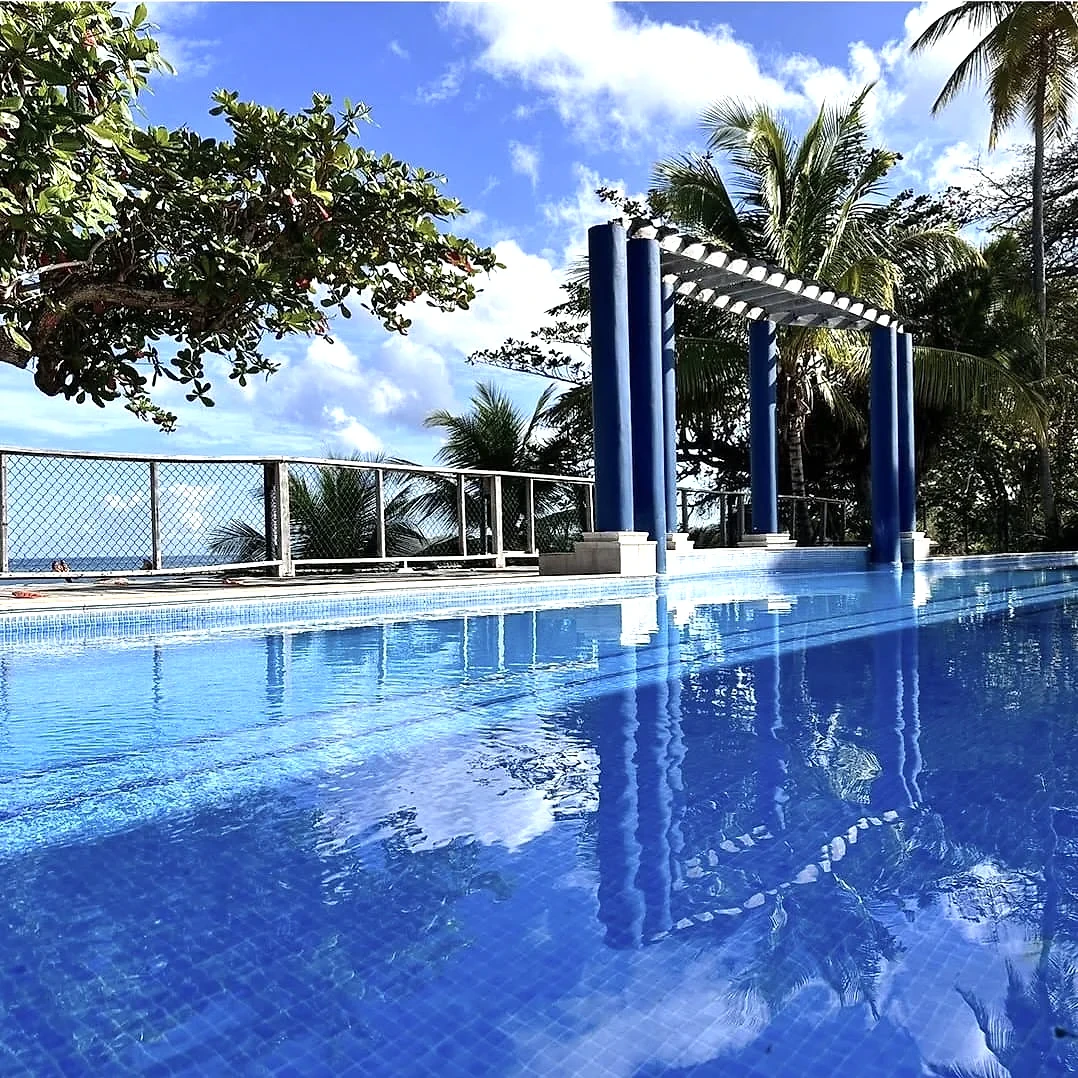 Sea view through the arched pool terrace at Sapodilla Villa