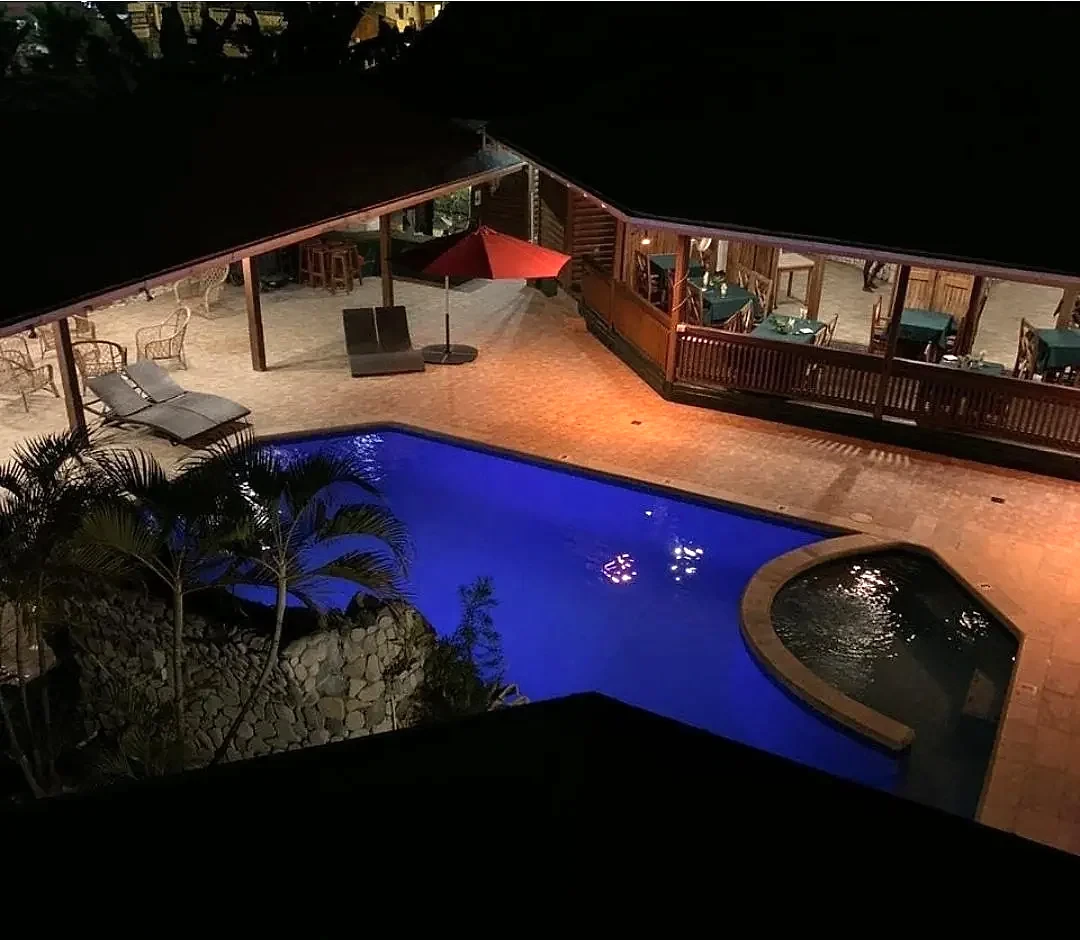 The pool and courtyard glowing at night
