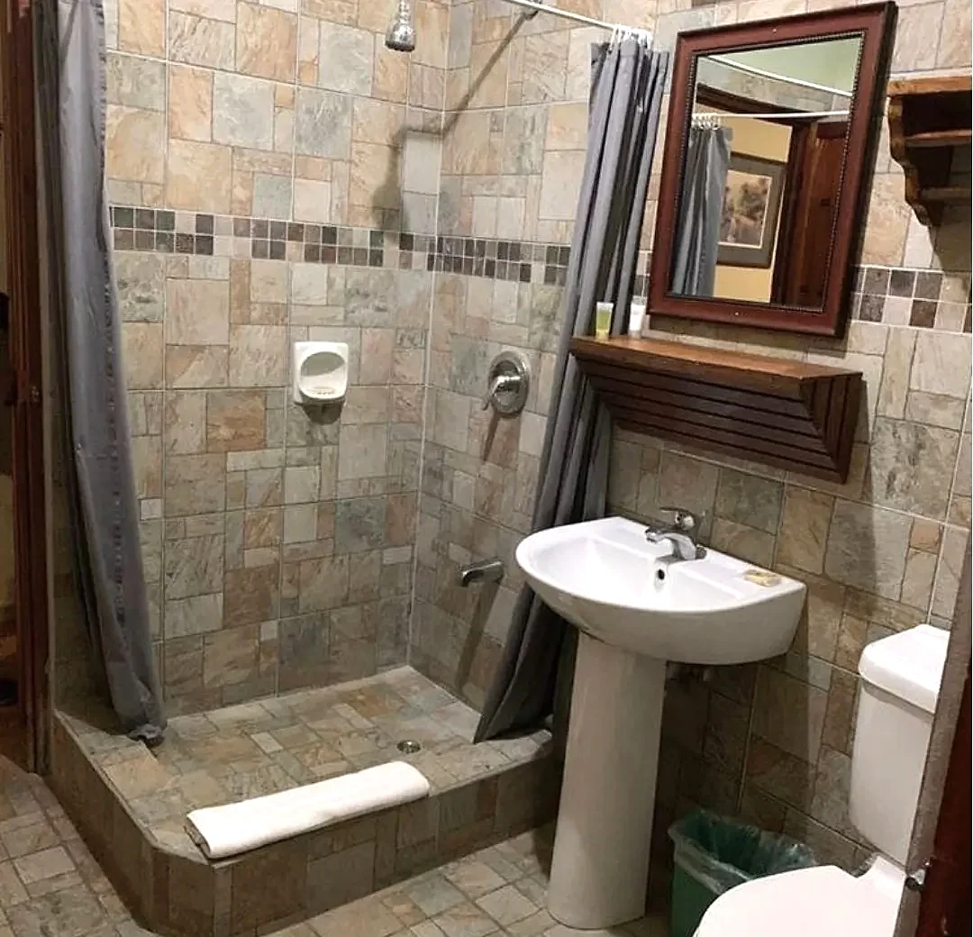 En-suite bathroom with stone-tiled walk-in shower